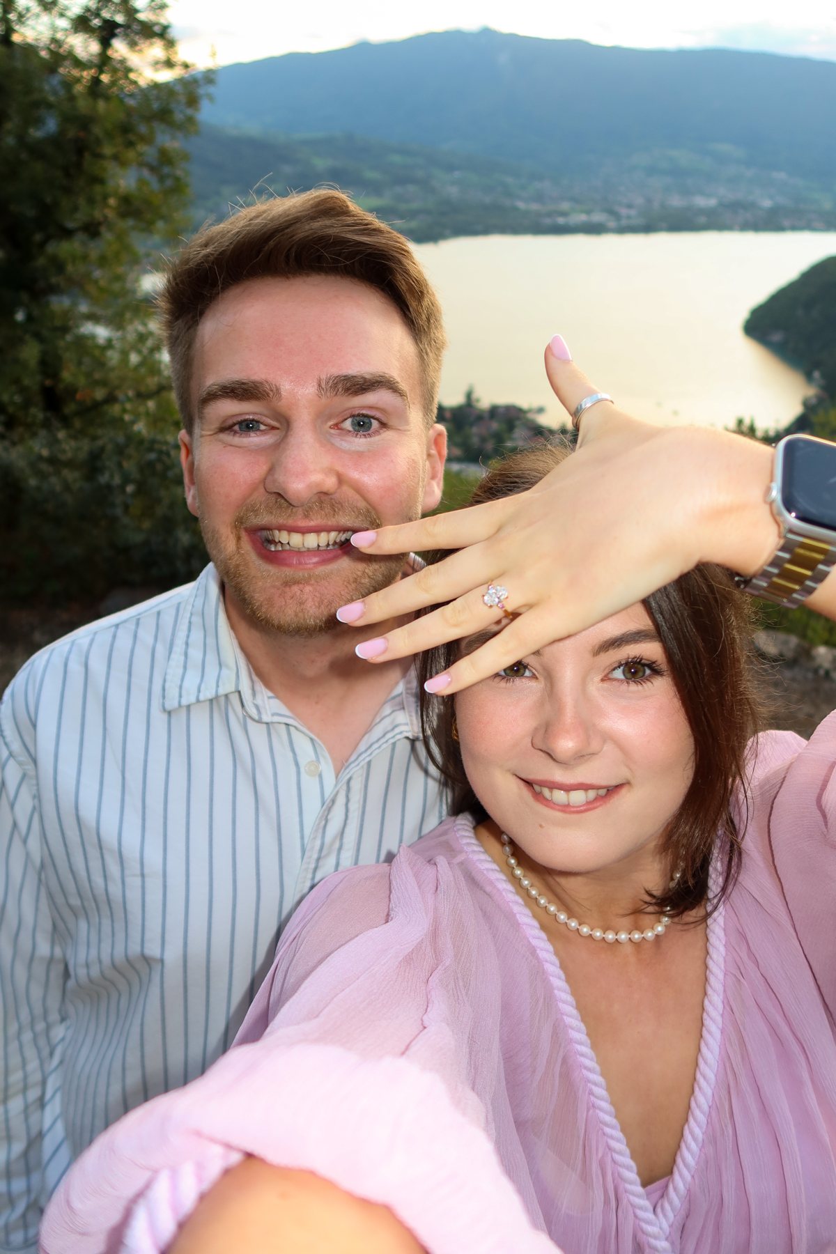 Ellie holding up her engagement ring beside Sam